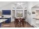 Dining room featuring large windows, bright natural light, and a view of the kitchen at 639 N 110Th Pl, Mesa, AZ 85207