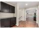 Hallway featuring dark cabinets and an open view of another room at 639 N 110Th Pl, Mesa, AZ 85207