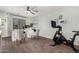 Bright and airy home office featuring a modern desk, comfortable chairs, and a Peloton bike for staying active at 639 N 110Th Pl, Mesa, AZ 85207