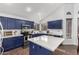 Bright kitchen featuring blue cabinets, stainless steel appliances, and quartz countertops at 639 N 110Th Pl, Mesa, AZ 85207