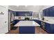 Kitchen featuring blue cabinets, stainless steel appliances, and a center island at 639 N 110Th Pl, Mesa, AZ 85207