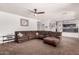 Living room area featuring plush carpet, an L-shaped couch, and bright walls at 639 N 110Th Pl, Mesa, AZ 85207