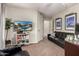 Living room with modern black leather couch, dark carpet, and entertainment center at 639 N 110Th Pl, Mesa, AZ 85207