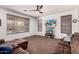 View of a cozy living room with plush carpet, ceiling fan and large window with wood blinds at 639 N 110Th Pl, Mesa, AZ 85207