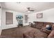 Spacious living room with comfortable seating, ceiling fan, and entertainment center at 639 N 110Th Pl, Mesa, AZ 85207