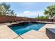 Beautiful pool featuring a waterfall and surrounded by desert landscaping at 639 N 110Th Pl, Mesa, AZ 85207
