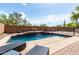Stunning pool with waterfall feature, surrounded by lush landscaping at 639 N 110Th Pl, Mesa, AZ 85207
