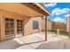 A covered back patio with backyard access with artificial turf at 6811 W Aire Libre Ave, Peoria, AZ 85382
