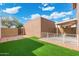 Backyard with artificial grass, patio, and block wall for privacy at 6811 W Aire Libre Ave, Peoria, AZ 85382