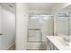 Bathroom featuring a shower-tub with a sliding door and a single sink at 6811 W Aire Libre Ave, Peoria, AZ 85382