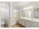 Bright bathroom with double sinks, white cabinets and a shower-tub combination at 6811 W Aire Libre Ave, Peoria, AZ 85382
