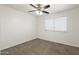 Neutral bedroom with carpet, a ceiling fan, and a window offering natural light and comfortable ambiance at 6811 W Aire Libre Ave, Peoria, AZ 85382