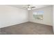 Carpeted bedroom with ceiling fan and a window that provides natural light and views, making it inviting at 6811 W Aire Libre Ave, Peoria, AZ 85382