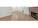 Spacious living room featuring tile floors, a cozy fireplace, staircase and fresh, white walls for a modern feel at 6811 W Aire Libre Ave, Peoria, AZ 85382