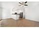 Open-plan living room with tile flooring and view of updated kitchen at 6811 W Aire Libre Ave, Peoria, AZ 85382