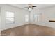 Open-plan living room with tile flooring and natural light from three windows at 6811 W Aire Libre Ave, Peoria, AZ 85382