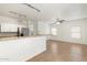 Open living space with tile floors, modern lighting, and a breakfast bar connecting to the kitchen at 6811 W Aire Libre Ave, Peoria, AZ 85382