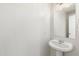 Clean powder room featuring a pedestal sink, framed mirror, and fresh paint, perfect for guests' convenience at 6811 W Aire Libre Ave, Peoria, AZ 85382