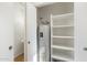 A utility closet with a water heater and shelving for storage at 6811 W Aire Libre Ave, Peoria, AZ 85382