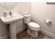 Simple bathroom with a pedestal sink and a modern toilet at 7158 E Posada Ave, Mesa, AZ 85212