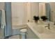 White bathroom with a shower-tub combo and a modern sink at 7158 E Posada Ave, Mesa, AZ 85212