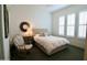 Comfortable bedroom with a rocking chair and bright natural light at 7158 E Posada Ave, Mesa, AZ 85212