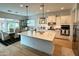 Modern kitchen featuring white cabinetry, stainless appliances, stone countertops and pendant lighting at 7158 E Posada Ave, Mesa, AZ 85212