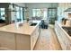 Bright kitchen with island, stainless steel appliances, and dining area view at 7158 E Posada Ave, Mesa, AZ 85212