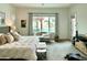 Spacious main bedroom featuring a cozy sitting area with views of the backyard pool at 7158 E Posada Ave, Mesa, AZ 85212