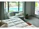 Bright main bedroom featuring a seating area, carpeted floors and pool views at 7158 E Posada Ave, Mesa, AZ 85212