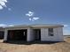 A partially finished home under construction shows a charming one story with an open garage and blue sky at 7707 W Avenida Del Rey --, Peoria, AZ 85383