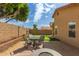 Inviting backyard with a patio seating area, lush greenery, and putting green at 7822 W Mcrae Way, Glendale, AZ 85308