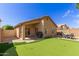 Spacious backyard with a putting green, patio, and well-maintained landscaping at 7822 W Mcrae Way, Glendale, AZ 85308