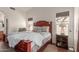 Cozy bedroom featuring a large, wooden bed frame and soft, neutral decor at 7822 W Mcrae Way, Glendale, AZ 85308