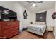 Bedroom featuring a large dresser, cozy bed, and a ceiling fan at 7822 W Mcrae Way, Glendale, AZ 85308