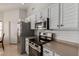 Clean kitchen featuring white cabinets, stainless steel appliances, and ample counter space at 7822 W Mcrae Way, Glendale, AZ 85308