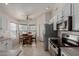 Open kitchen and breakfast nook with stainless steel appliances and ample counter space at 7822 W Mcrae Way, Glendale, AZ 85308
