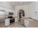 Bright, updated kitchen with white cabinets and stainless steel appliances at 7822 W Mcrae Way, Glendale, AZ 85308