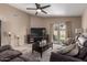 Comfortable living room featuring vaulted ceiling, neutral tones and a ceiling fan at 7822 W Mcrae Way, Glendale, AZ 85308