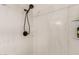 Modern shower with marble-style tiling and a sleek, handheld shower head at 7822 W Mcrae Way, Glendale, AZ 85308