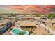 Expansive aerial view of a home highlighting a backyard with a pool, covered patio, and secure fencing in a residential neighborhood at 809 N 95Th St, Mesa, AZ 85207