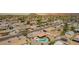 Expansive aerial shot of a neighborhood featuring a property with a backyard pool and outdoor living space, enhanced with desert landscaping at 809 N 95Th St, Mesa, AZ 85207