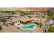 Aerial view showcasing the kidney-shaped pool, covered patio, and mature landscaping of a property in a quiet residential area at 809 N 95Th St, Mesa, AZ 85207