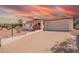 Charming single-story home with desert landscaping, a covered porch, and a two-car garage at 809 N 95Th St, Mesa, AZ 85207