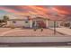 Charming single-story home with desert landscaping, a covered porch, and a two-car garage at 809 N 95Th St, Mesa, AZ 85207