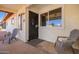 Comfortable front porch with seating, a secure security door, and an inviting entrance to the home at 809 N 95Th St, Mesa, AZ 85207