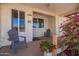 Welcoming front porch with cozy seating and charming details, creating a perfect spot for relaxation at 809 N 95Th St, Mesa, AZ 85207