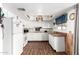 Efficient kitchen features white cabinets and hardwood floors at 809 N 95Th St, Mesa, AZ 85207
