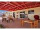 Charming covered patio with brick flooring, ideal for outdoor dining and entertaining at 809 N 95Th St, Mesa, AZ 85207