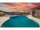 Beautiful backyard pool area with lounge chair, covered patio, and a privacy fence with murals and climbing roses at 809 N 95Th St, Mesa, AZ 85207